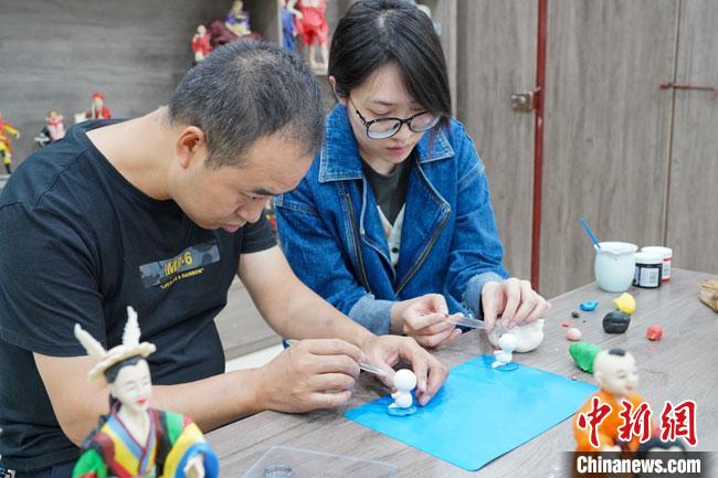 <a target='_blank'  data-cke-saved- >中新社</a>記者(右)現(xiàn)場體驗(yàn)面塑制作過程。　陳爭強(qiáng) 攝
